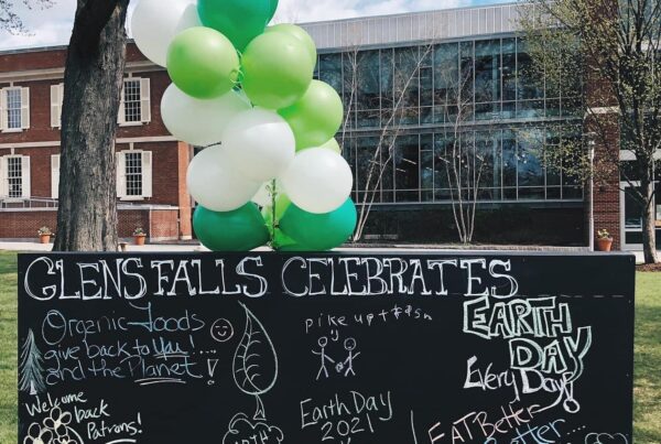 Chalkboard in City Park for Earth Day with green balloons